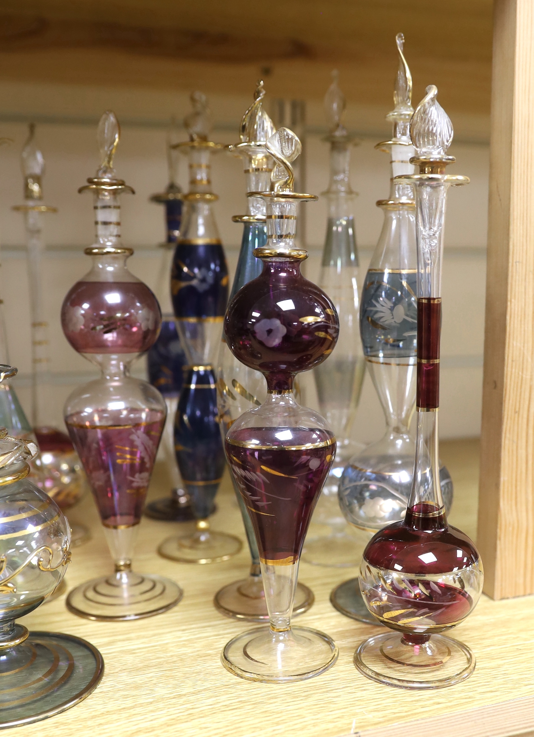 A collection of gilded glass scent bottles and stoppers, 27cm